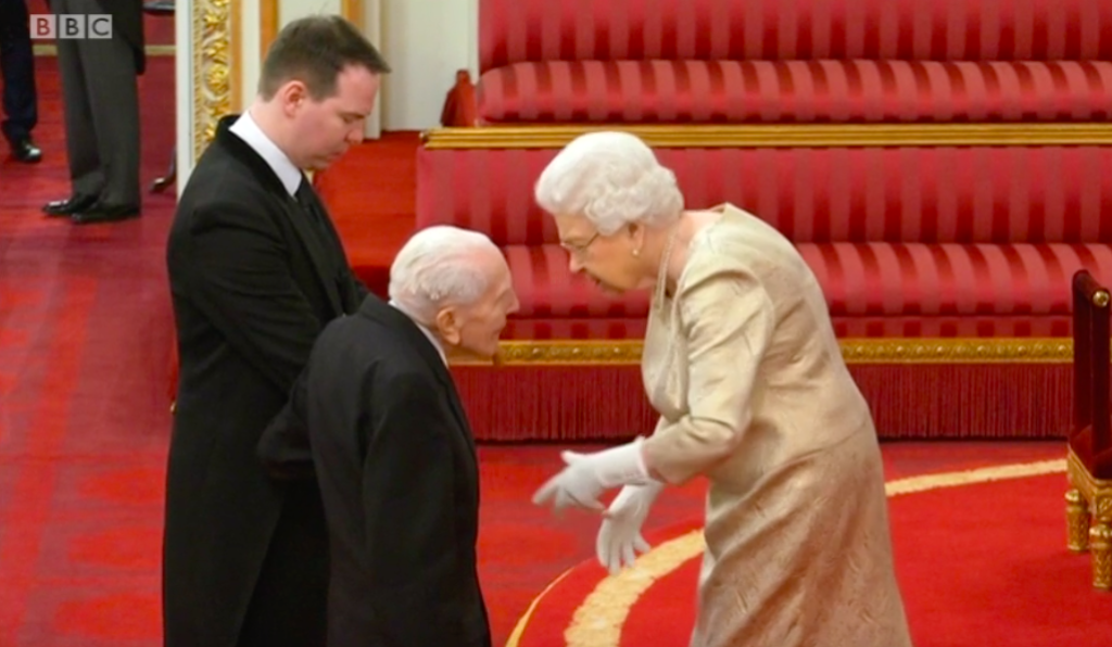 The Queen wears gloves for the first time during an investiture as