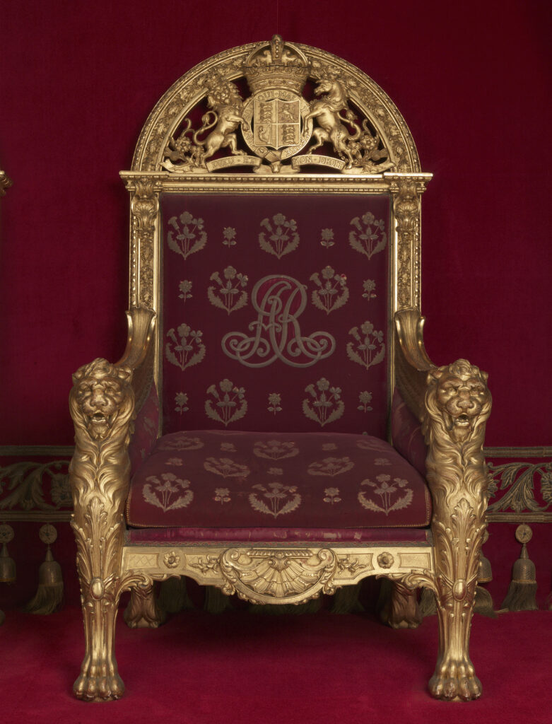 The Coronation chair of Queen Alexandra, covered in red velvet, and now on show in London