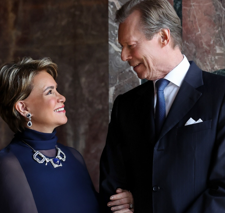 Grand Duchess Maria Teresa of Luxembourg smiles at her husband Grand Duke Henri in a fashion portrait