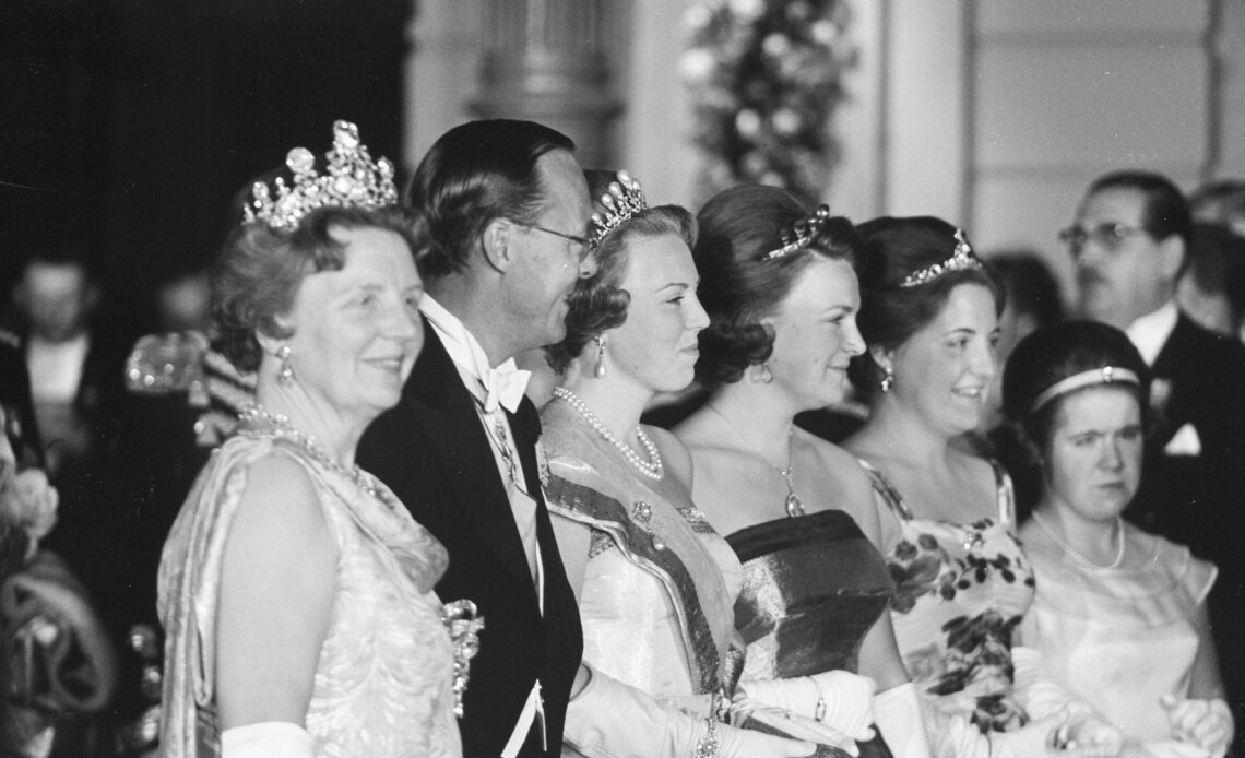 Queen Juliana stands in a row with her daughters