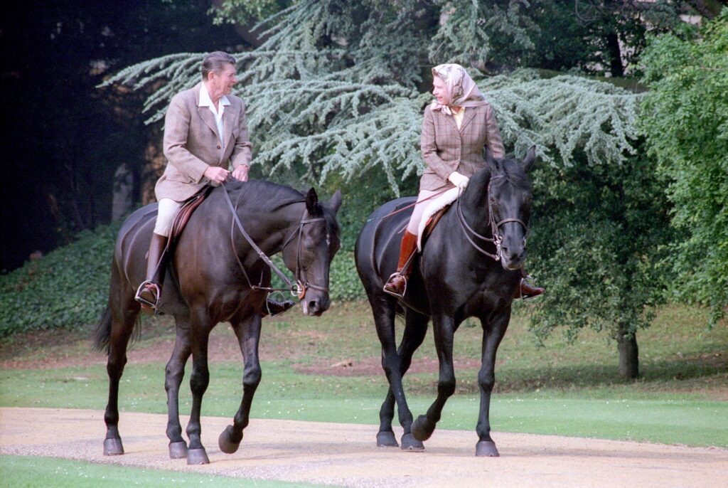 Queen Elizabeth II rides Burmese during an outing with Ronald Reagan at Windsor