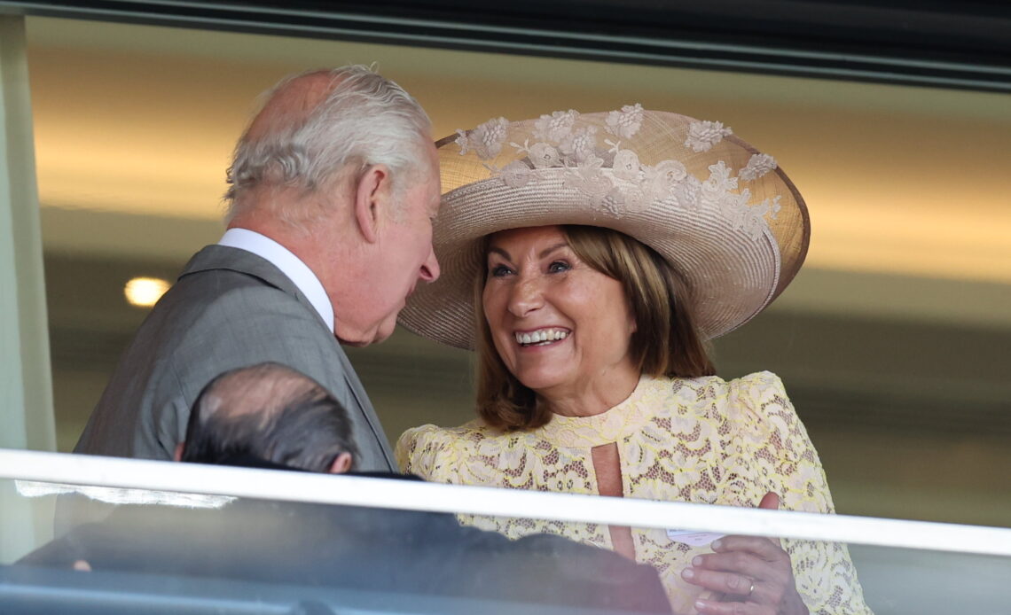 King Charles talks to Carole Middleton as they enjoy day two of Royal Ascot in warm sunshine