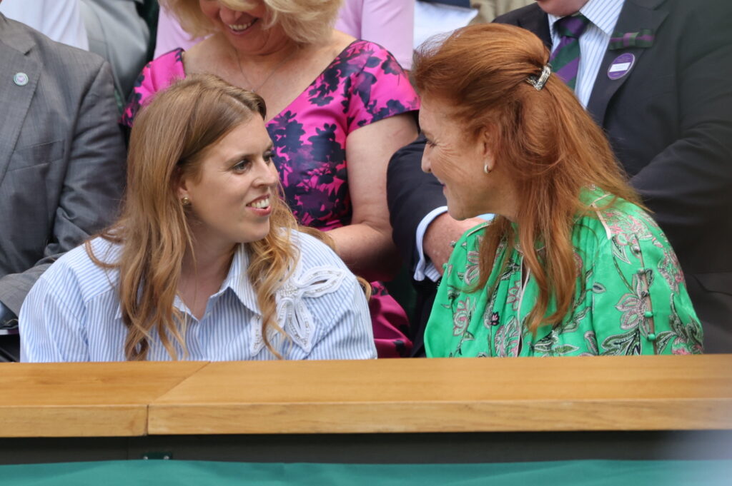 Princess Beatrice, in a cool blue striped shirt dress, is joined by her mother, Sarah, Duchess of York, in the royal box on the opening day of Wimbledon 2025.