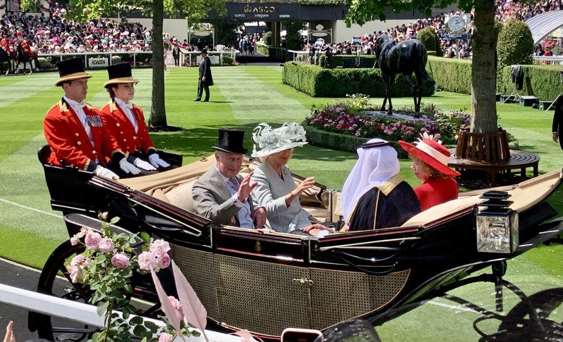 The King and Queen wave as they arrive in the Royal Enclosure at Royal Ascot after the carriage procession on Day One of the 2025 meeting