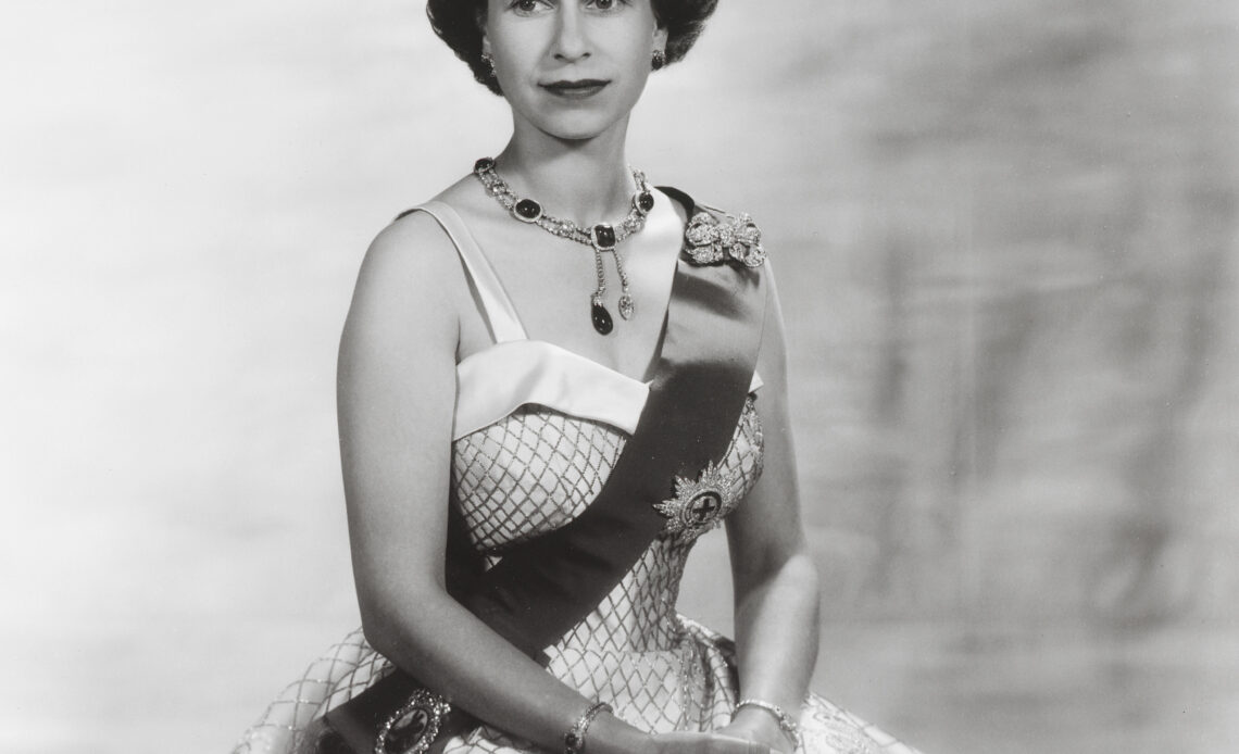 Queen Elizabeth II in a gown by Norman Hartnell and the Vladimir tiara set with emeralds.