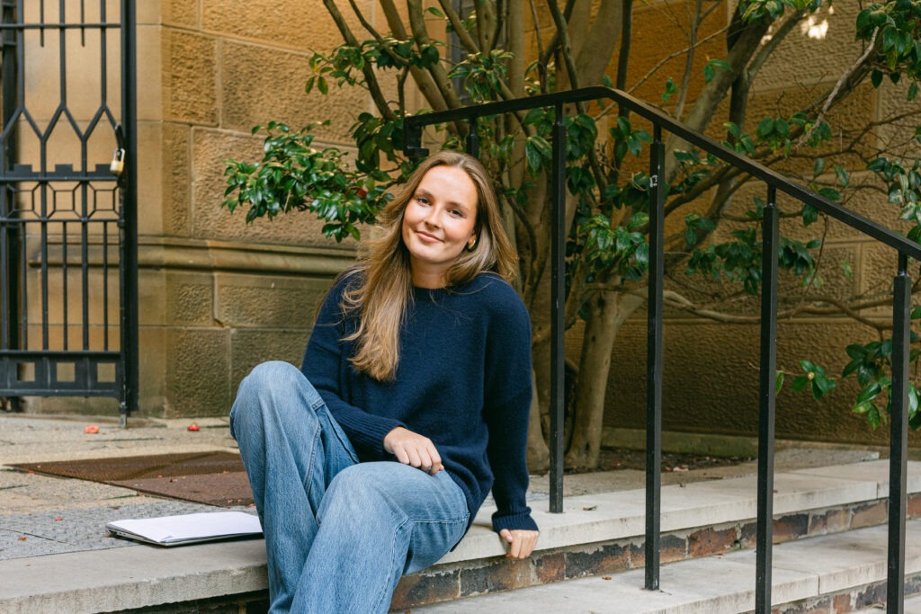 Princess Ingrid Alexandra of Norway sits on stone steps at her new university in Sydney, Australia