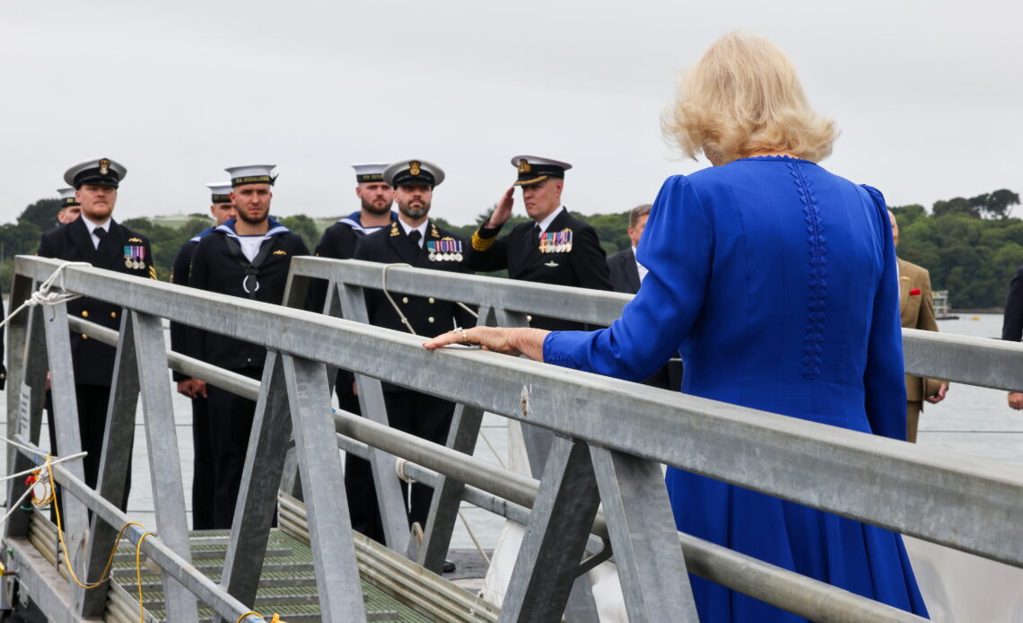 Queen Camilla walks on to HMS Astute for a ceremony marking her historic appointment as Vice Admiral of the United Kingdom