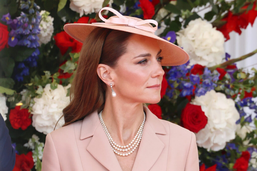 The Princess of Wales in a bar jacket by Dior and a 1940s style hat by Jess Collett at the official welcome ceremony for the State Visit of the President of France