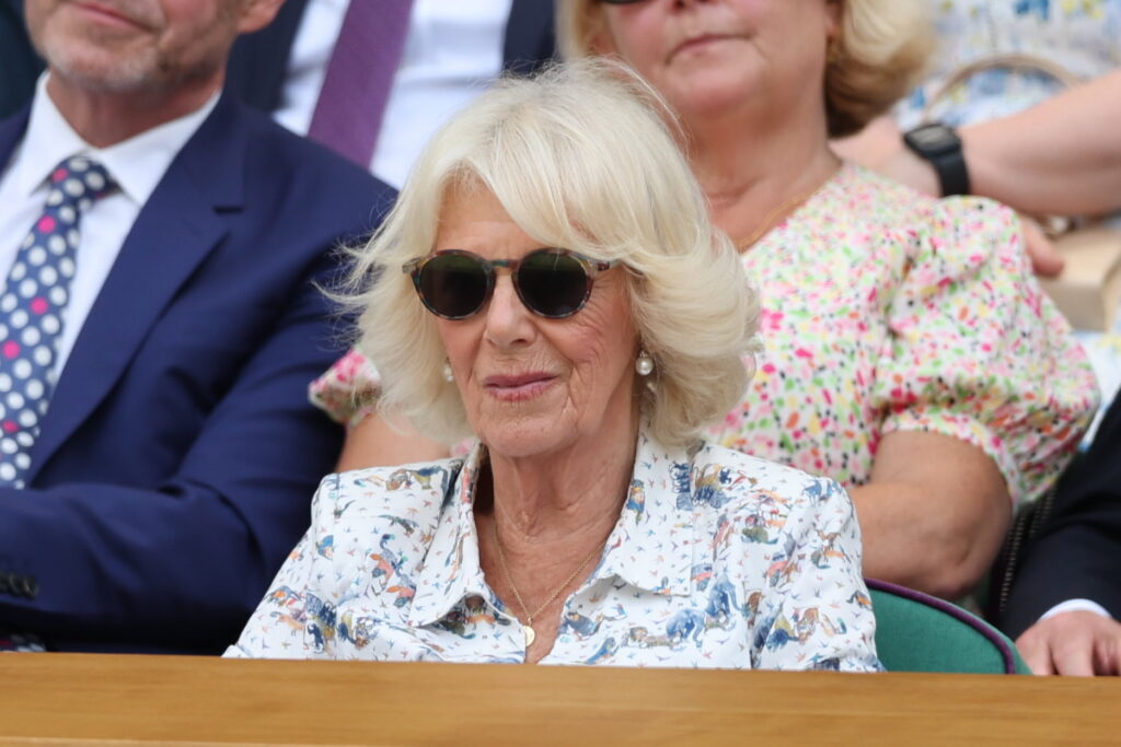 Queen Camilla wears sunglasses as she watches Wimbledon from the royal box where she was joined by Peter Phillips and his partner, Harriet Sperling, whose royal romance was given another seal of approval.