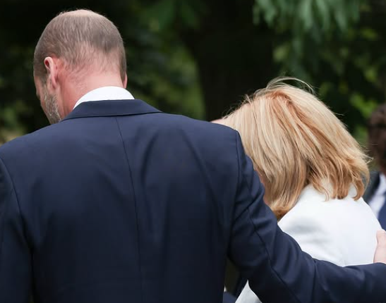 The Prince of Wales supports a mourner at a commemoration of the 7/7 bombings