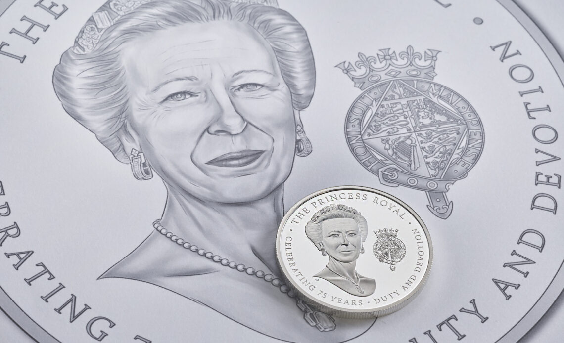 A close up of a commemorative coin showing Princess Anne