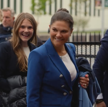 Crown Princess Victoria and Princess Estelle of Sweden in blue to watch an athletics contest