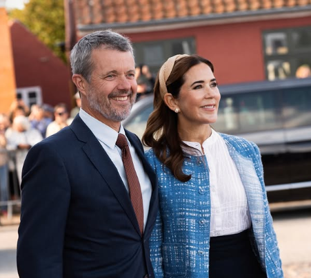 King Frederik and Queen Mary smile as they arrive in Saeby
