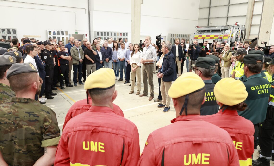 King Felipe and Queen Letizia speak to firefighters