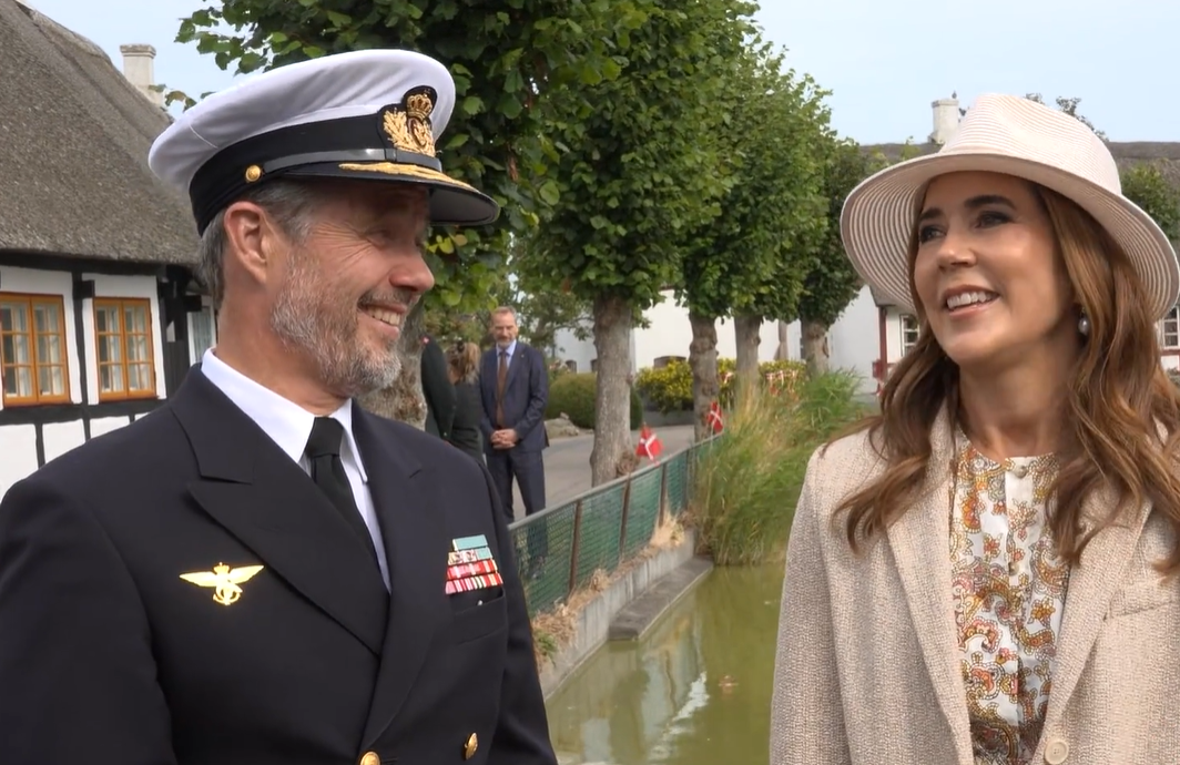 King Frederik and Queen Mary smile as they are asked about their daughter