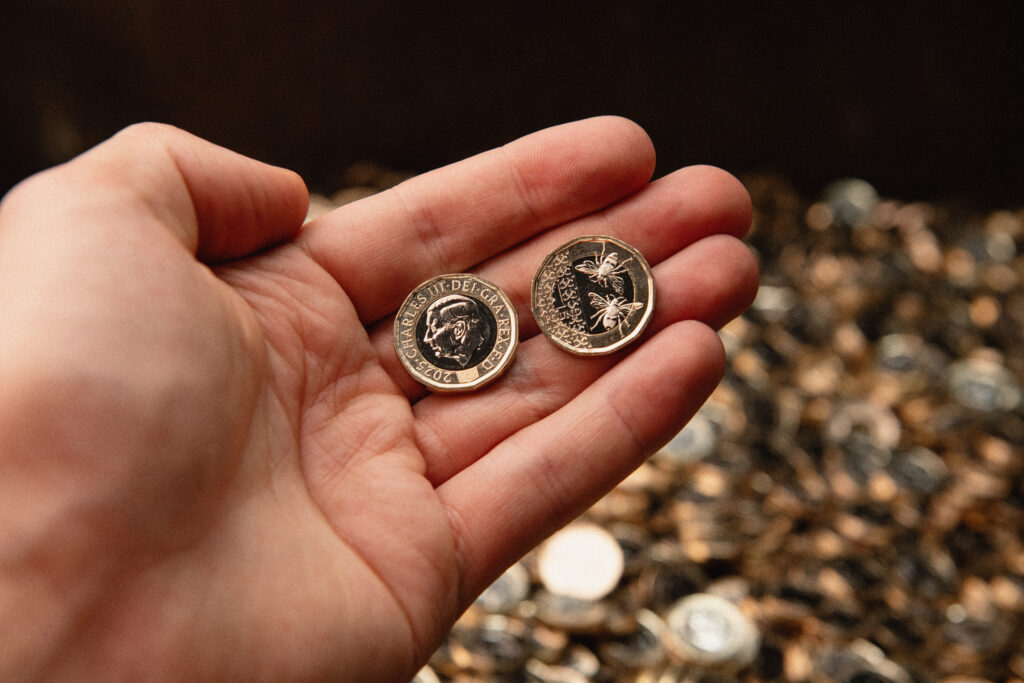 Pound coins bearing the image of King Charles III