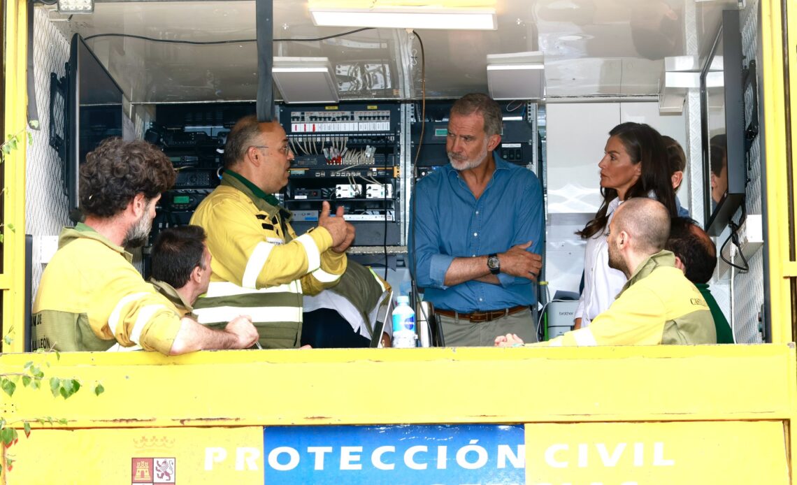 King Felipe and Queen Letizia talk to first responders working to put out wildfires