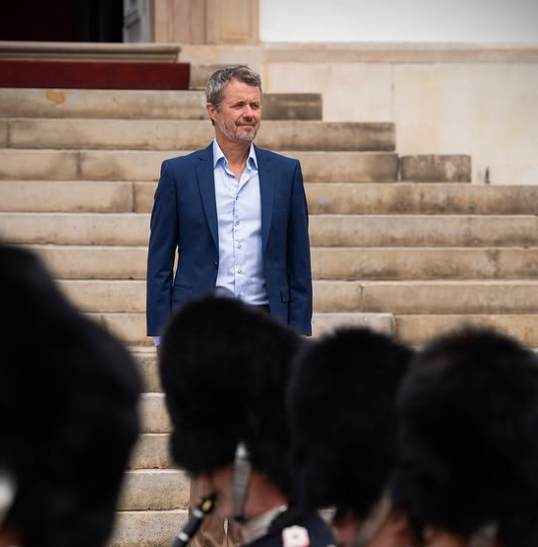 King Frederik of Denmark watches the Changing of the Guard at Fredensborg Palace.