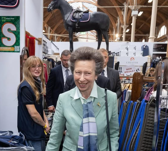 Princess Anne stands in front of a statue of a horse as she visits the 150th edition of the Dublin Horse Show.