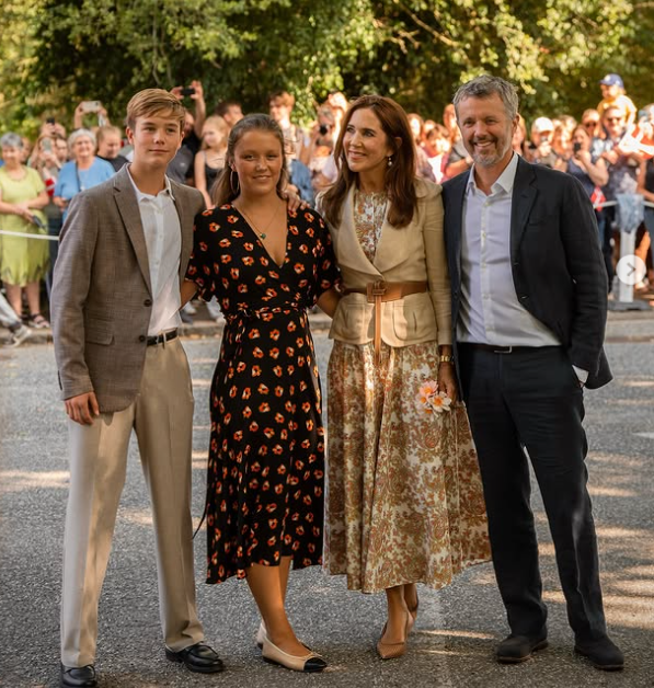 King Frederik and Queen Mary of Denmark stand with two of their children, Princess Isabella and Prince Vincent, as the Danish royals arrive for their summer holiday at Grasten