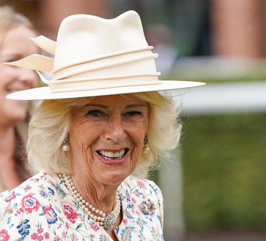 Queen Camilla in a cream coloured trilby and red, white and blue dress on a visit to the Ebor Festival at York Racecourse