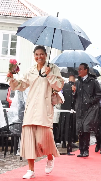 Crown Princess Victoria makes a style statement in heavy rain by swapping heels for trainers
