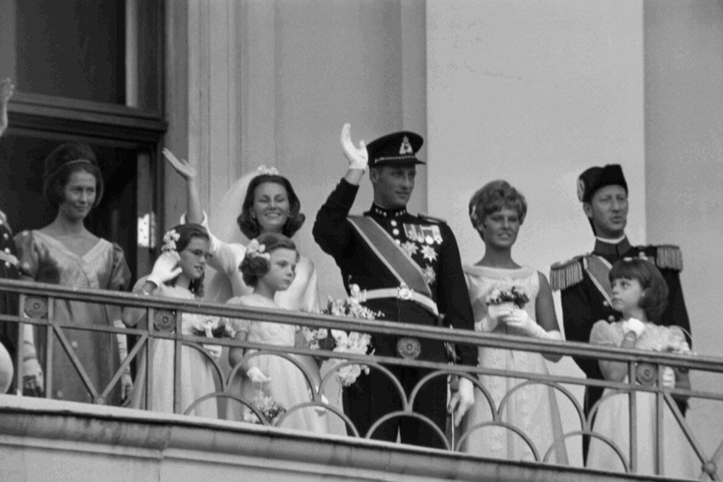 King Harald and Queen Sonja wave from the balcony of Oslo Palace after their wedding in 1968