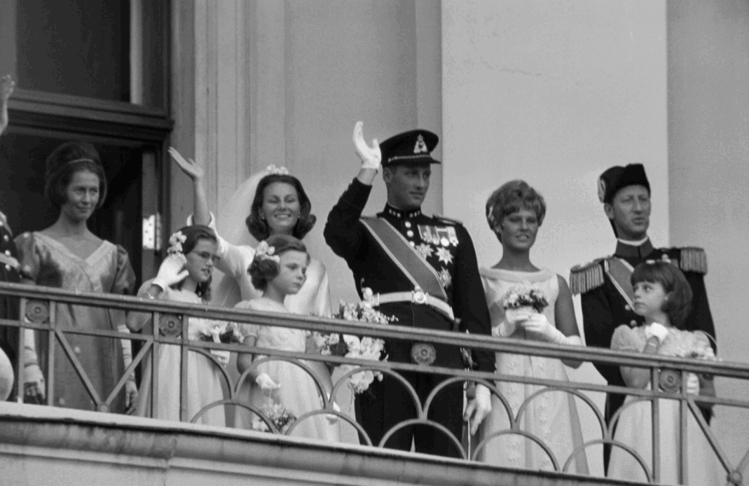 King Harald and Queen Sonja wave from the balcony of Oslo Palace after their wedding in 1968