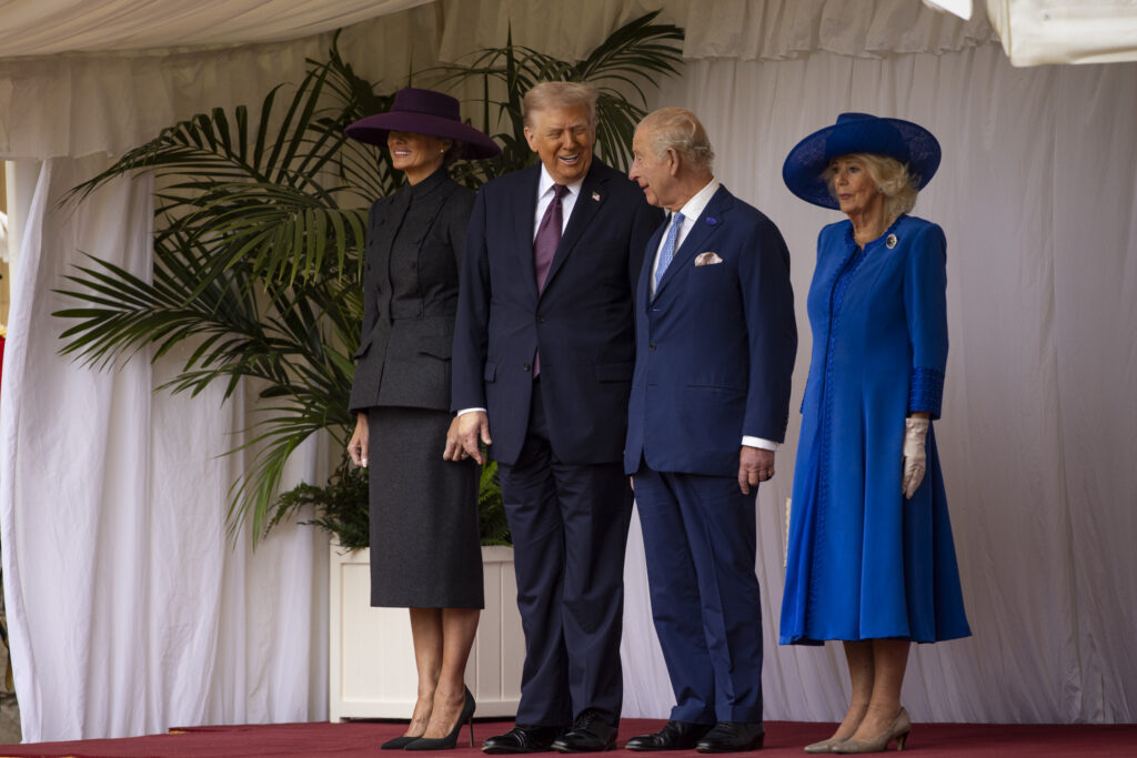 King Charles, Queen Camilla, Donald Trump and Melania Trump stand on a dais in the Quadrangle at Windsor Castle for the official welcome ceremony at the start of the US State Visit