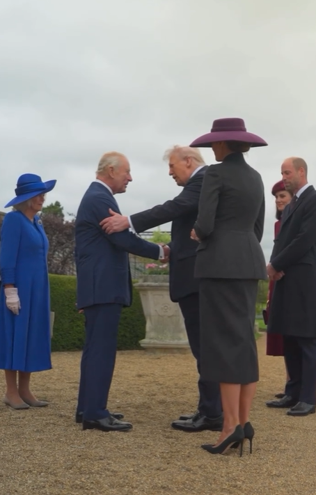 Donald Trump shakes hands with King Charles and places another hand on his shoulder as he talks to him at the start of the US State Visit to the UK