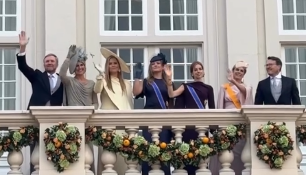 The Dutch royal family, including the three princesses, wave from the balcony after the Throne speech