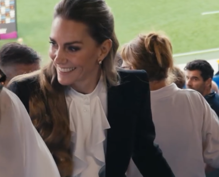 Kate, The Princess of Wales in a trouser suit walks to her seat at the Women's Rugby World Cup