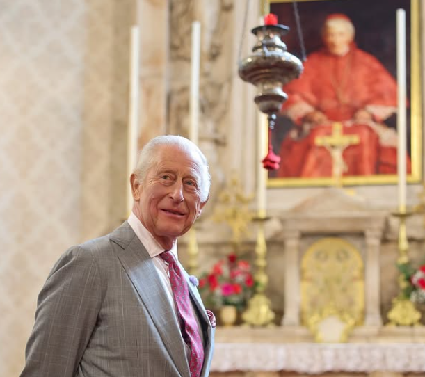 King Charles stands in front of a portrait of one of England's newest saints, John Henry Newman