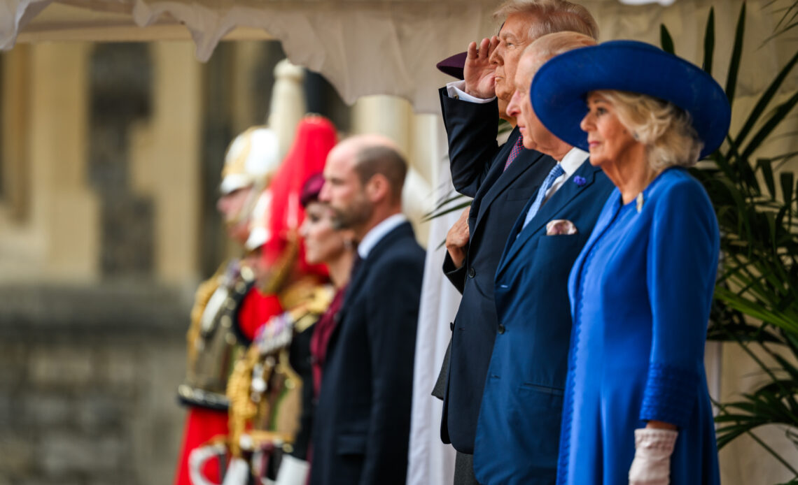 US President, Donald Trump, salutes at a welcome ceremony at Windsor Castle at the start of his State Visit. King Charles stands at his side. Queen Camilla, in royal blue, is at the front of the line up in the photo.