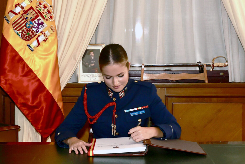 Princess Leonor signs the guest book as she arrives for military training