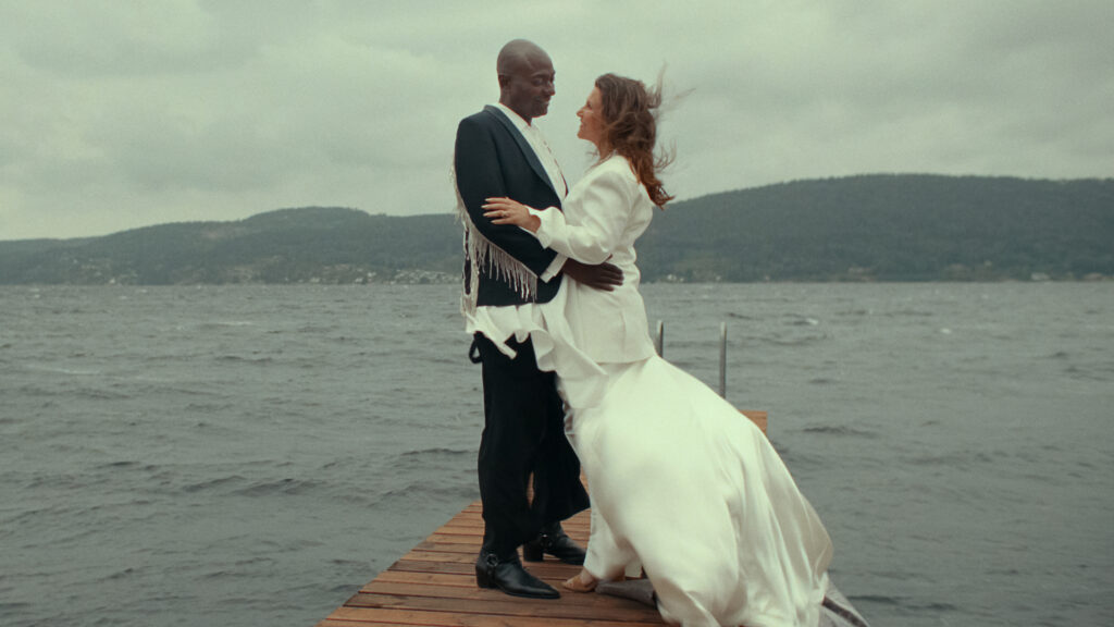 Princess Martha Louise of Norway and Durek Verrett stand on a rock in their wedding outfits in their new show on Netflix
