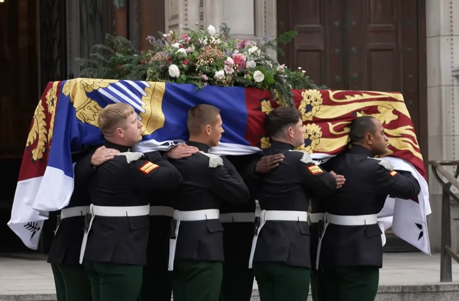 The coffin of the Duchess of Kent is carried by a bearer party of the Royal Dragoon Guard at Westminster Cathedral