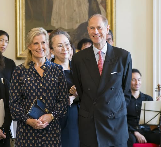 The Duke and Duchess of Edinburgh, wearing dark colours, arrive in Japan