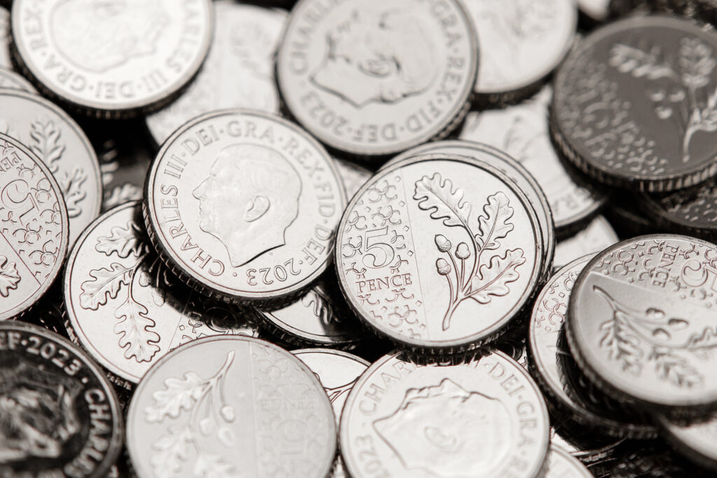 A pile of 5p coins bearing the image of King Charles are sent to a Post Office, a royal first