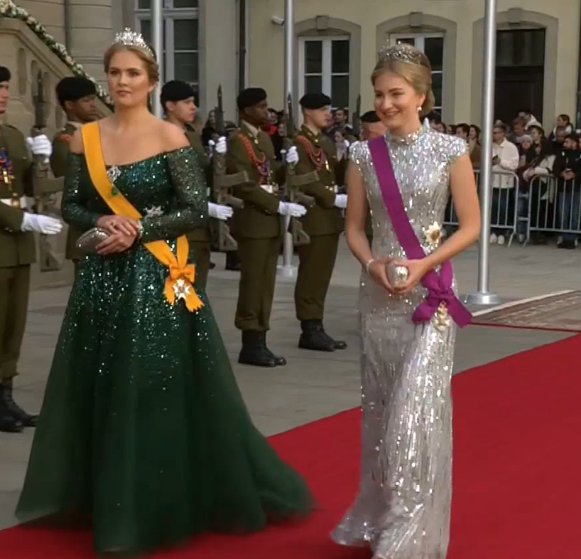 Princess Amalia of the Netherlands in an emerald green ballgown and Princess Elisabeth in a silver sequinned column dress