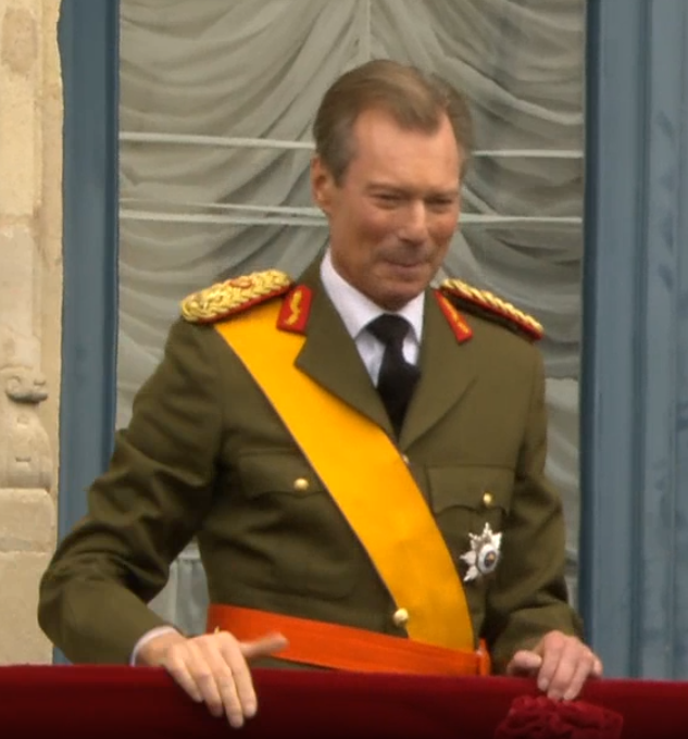 Grand Duke Henri struggles to hold in tears as he appears on the royal balcony after abdicating