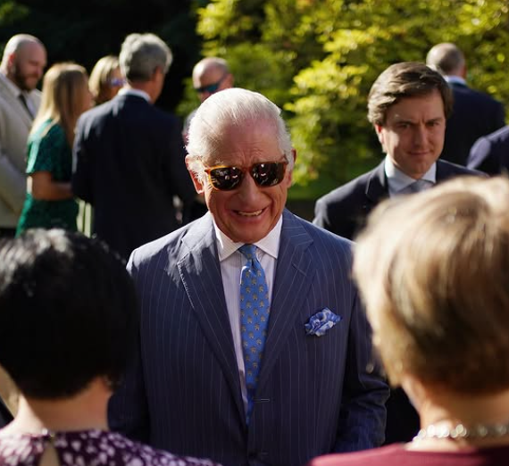 King Charles shows off a new hairstyle with his grey locks slicked back across his head
