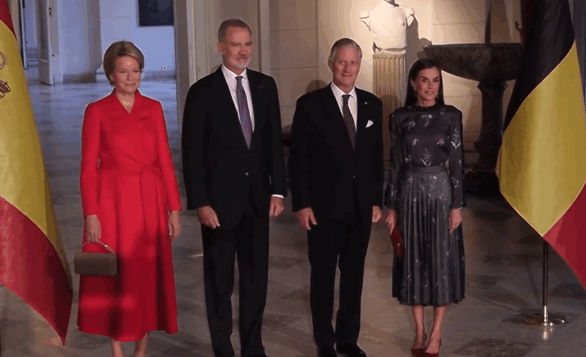 King Felipe, King Philippe, Queen Letizia and Queen Mathilde pose in front of Belgian and Spanish flags