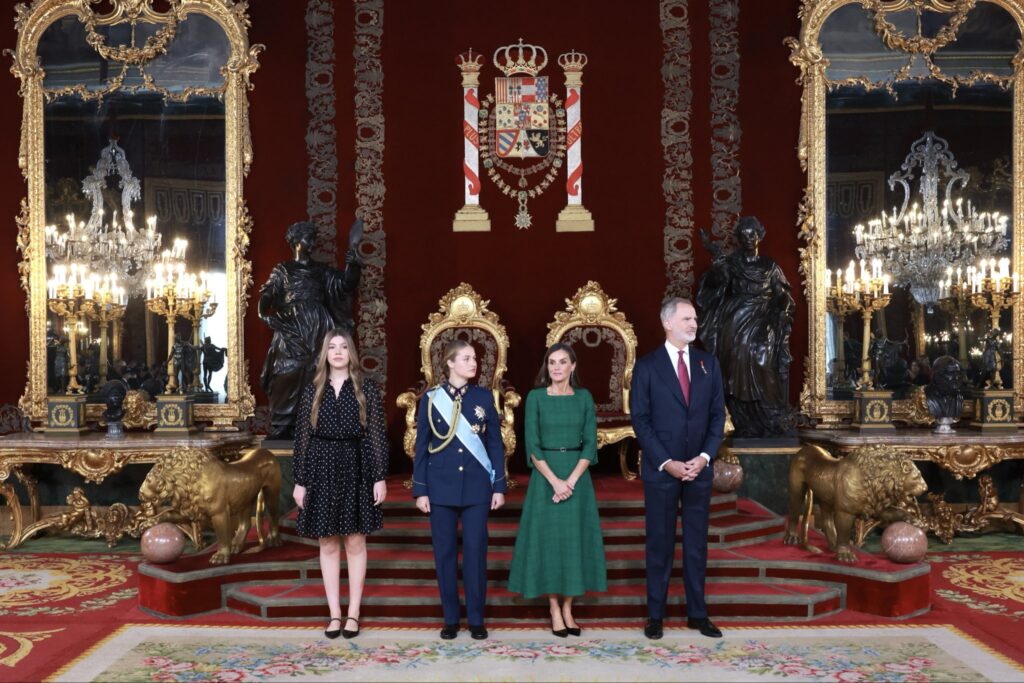 King Felipe, Queen Letizia and their daughters stand in the throne room at the Royal Palace in Madrid