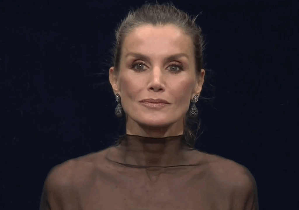 Queen Letizia wears a black dress with a sheer shoulder detail