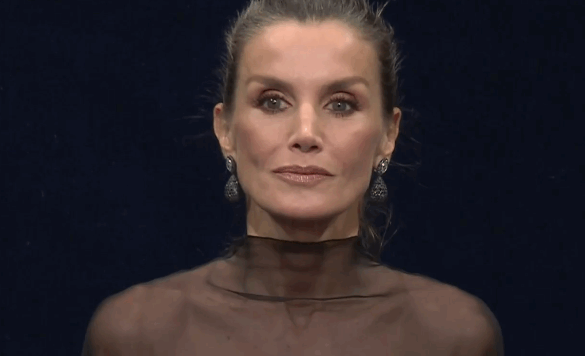 Queen Letizia wears a black dress with a sheer shoulder detail