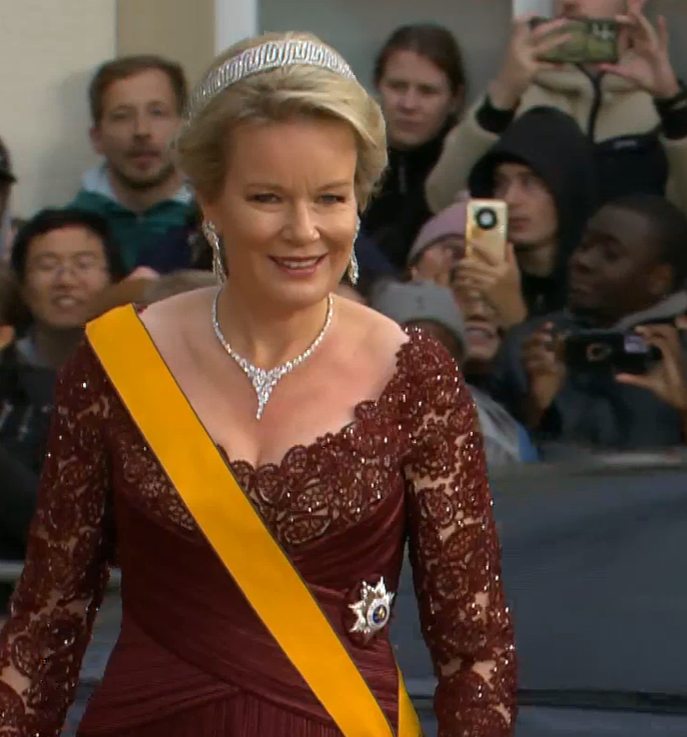 Queen Mathilde wears a burgundy lace evening dress and diamond tiara
