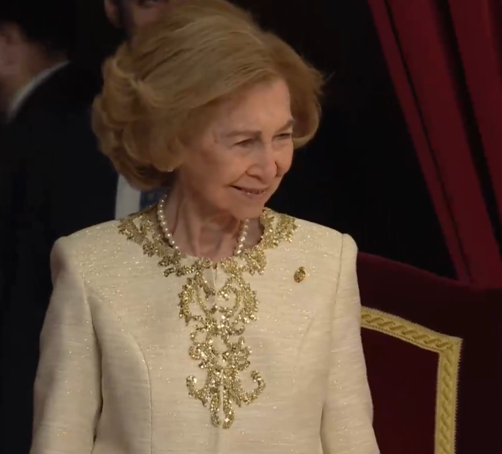 Queen Sofia of Spain in a cream coloured jacket with gold piping