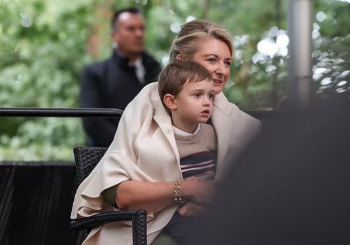 Grand Duchess Stephanie wraps her son, Prince Charles, up in her coat to keep him warm in a mum moment