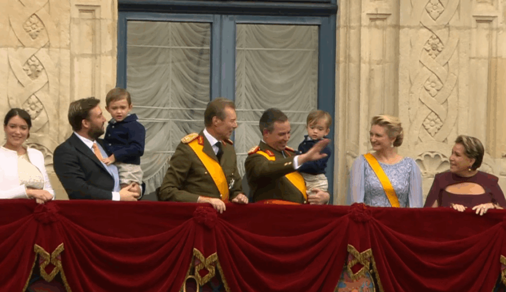 Prince Sebastien of Luxembourg holds his nephew, Prince Charles, as the royal family gather on the palace balcony
